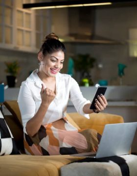successful woman using phone at home